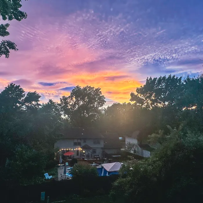 A colorful sunset viewed from a backyard